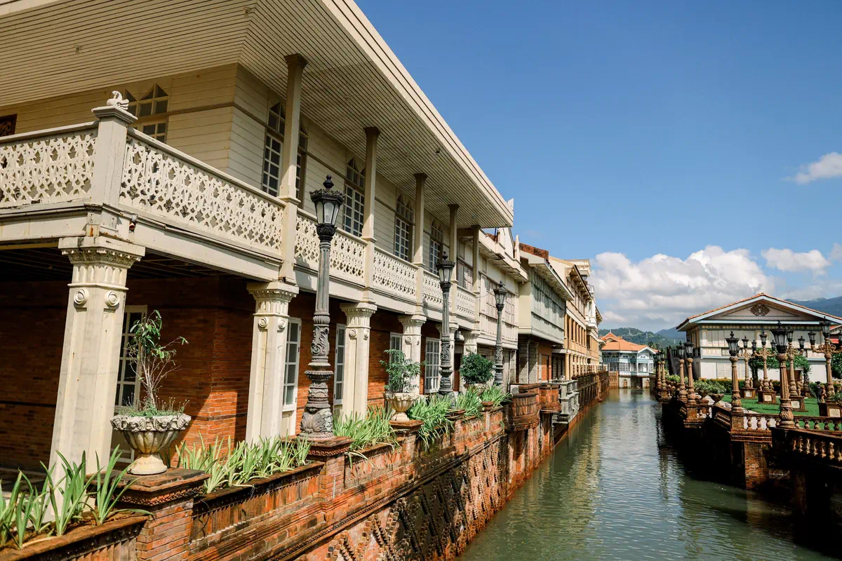 Philippine heritage-style waterfront accommodation beneath a clear blue sky