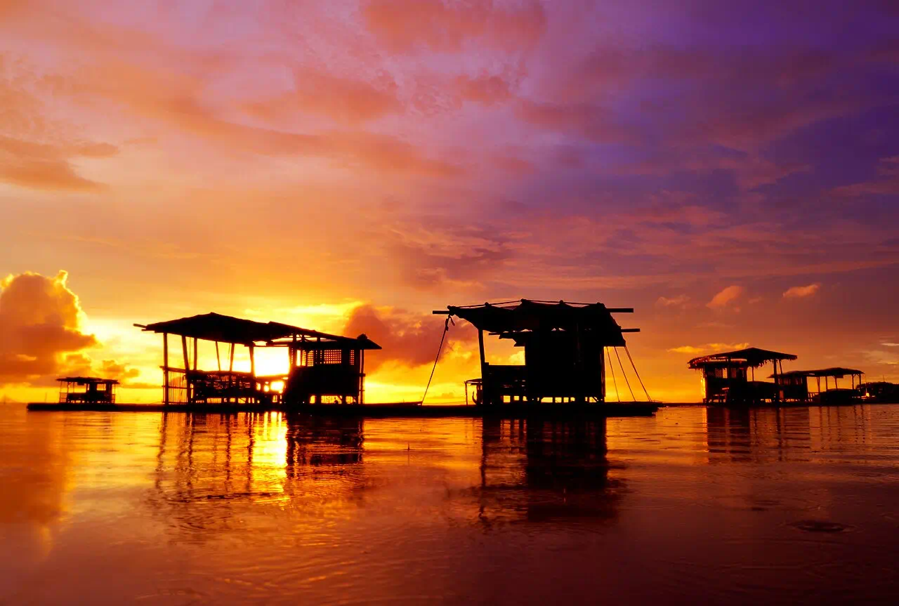 Sunset and floating cottages at Matabungkay Beach